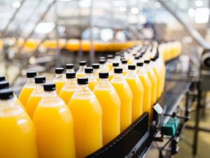 istockphoto-1041022570-612x612 Bottling factory - Orange juice bottling line for processing and bottling juice into bottles. Selective focus.